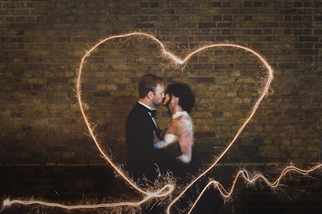 Brixton East warehouse wedding photography London - heart shape sparkle long exposure image, bride and groom kiss