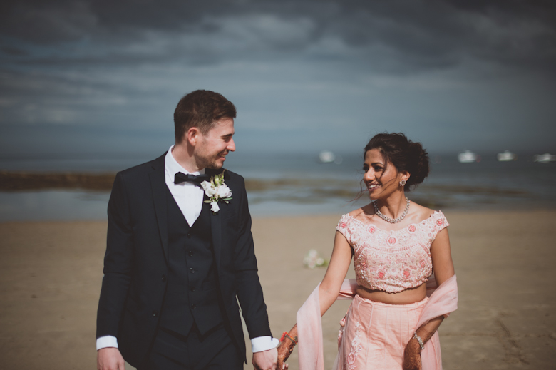 bride and groom walking - Western Asian Wedding Photography - Destination wedding photographer - Nrothumberland coast wedding