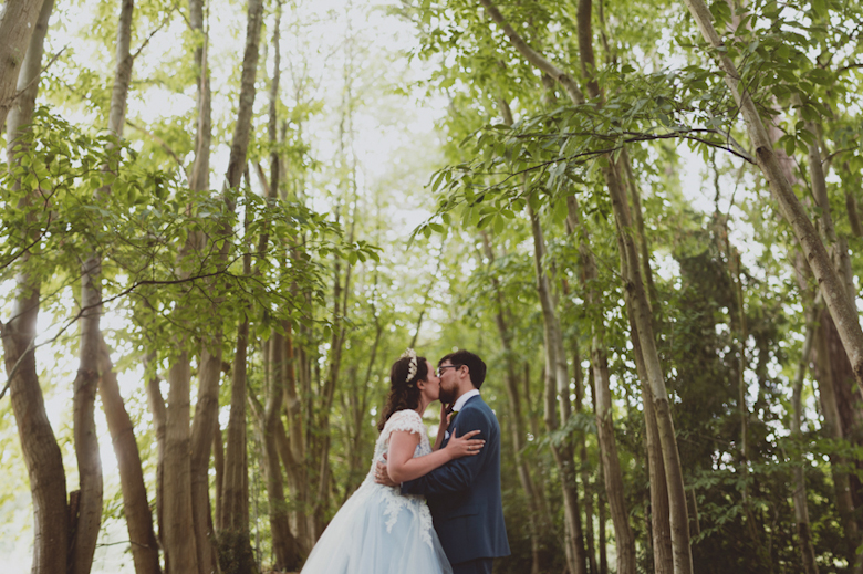 woodland wedding - bride and groom kiss