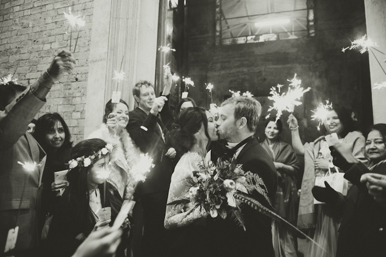 bride and groom kiss and sparklers