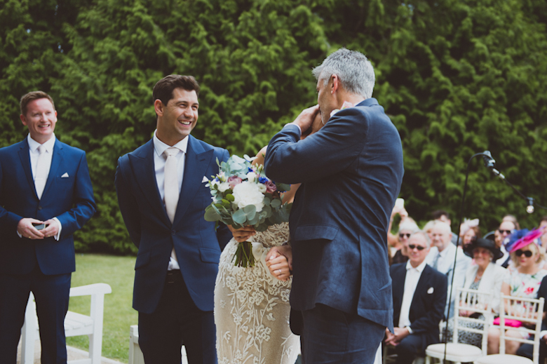 dad hugs bride at ceremony Festival Wedding, outdoor festival wedding, Knighton House, Dorset