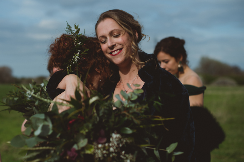 bride and bridesmaid hugging