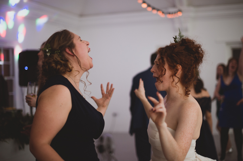 bride and bridesmaid dancing and singing