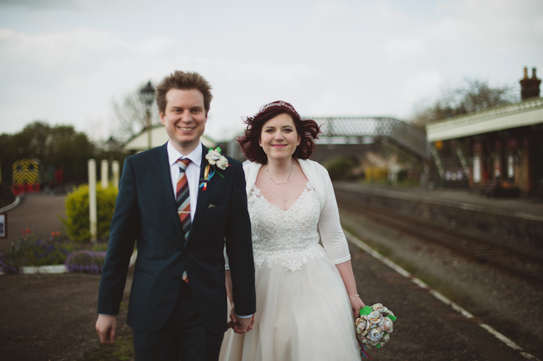 bride and groom walking at the train station