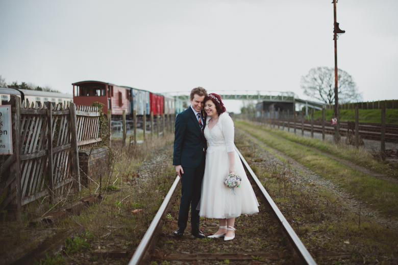 bride and groom on the train tracks