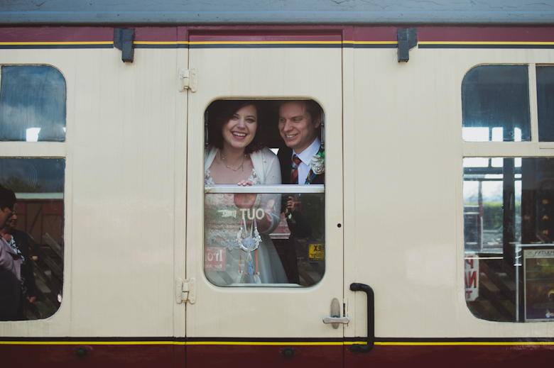 bride and groom in the train's window