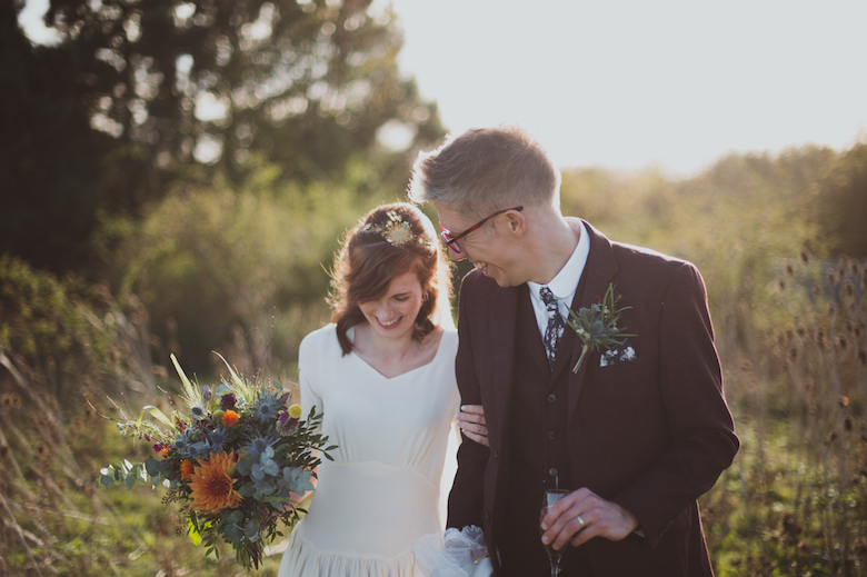 bride and groom walking laughing