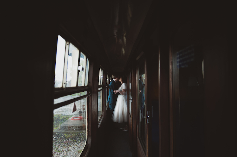 Candid wedding photography - Bride and groom kiss - Buckinghamshire Railway centre wedding