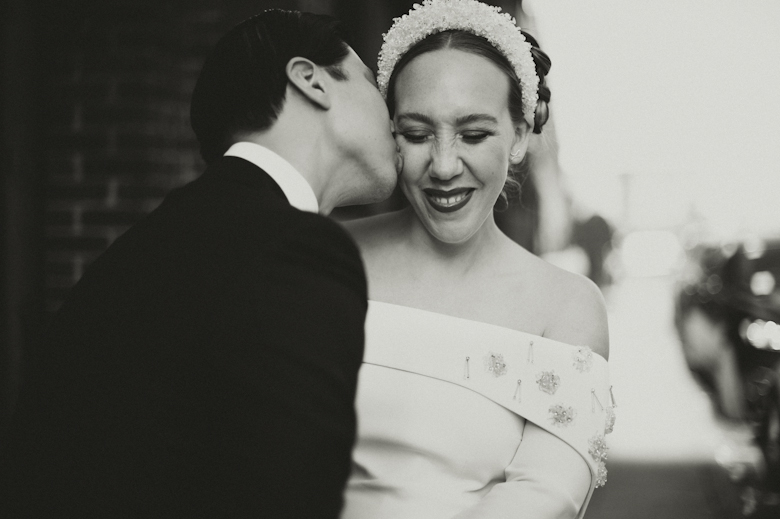 Groom kissing bride at the Bistrotheque, East London Wedding