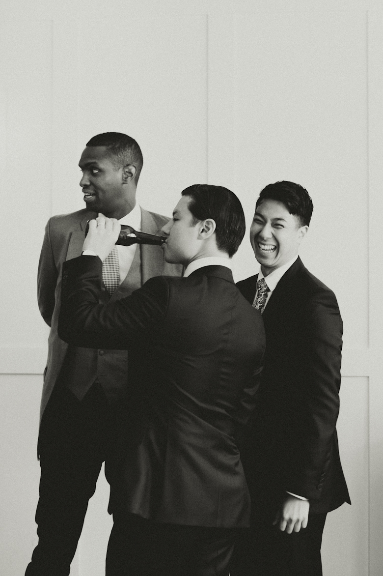 Groom and friends hanging out drinking laughing at the Bistrotheque, East London Wedding