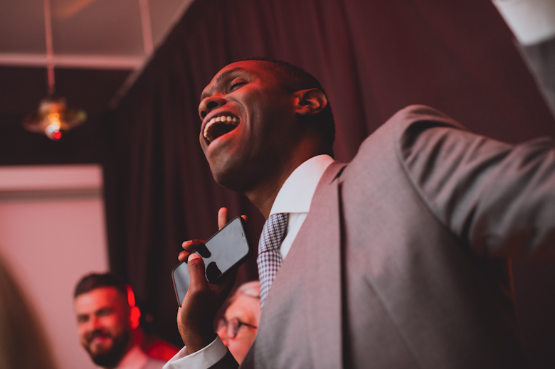 Guests dancing and singing at the wedding reception East London