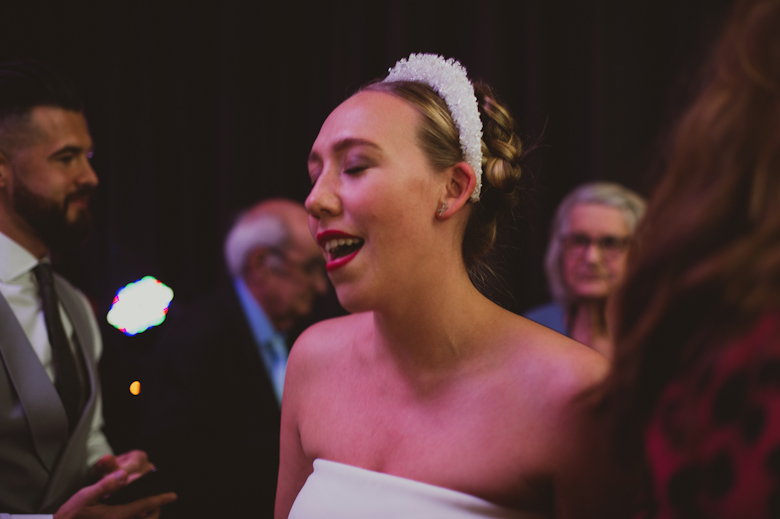 Bride dancing and singing at the wedding reception East London