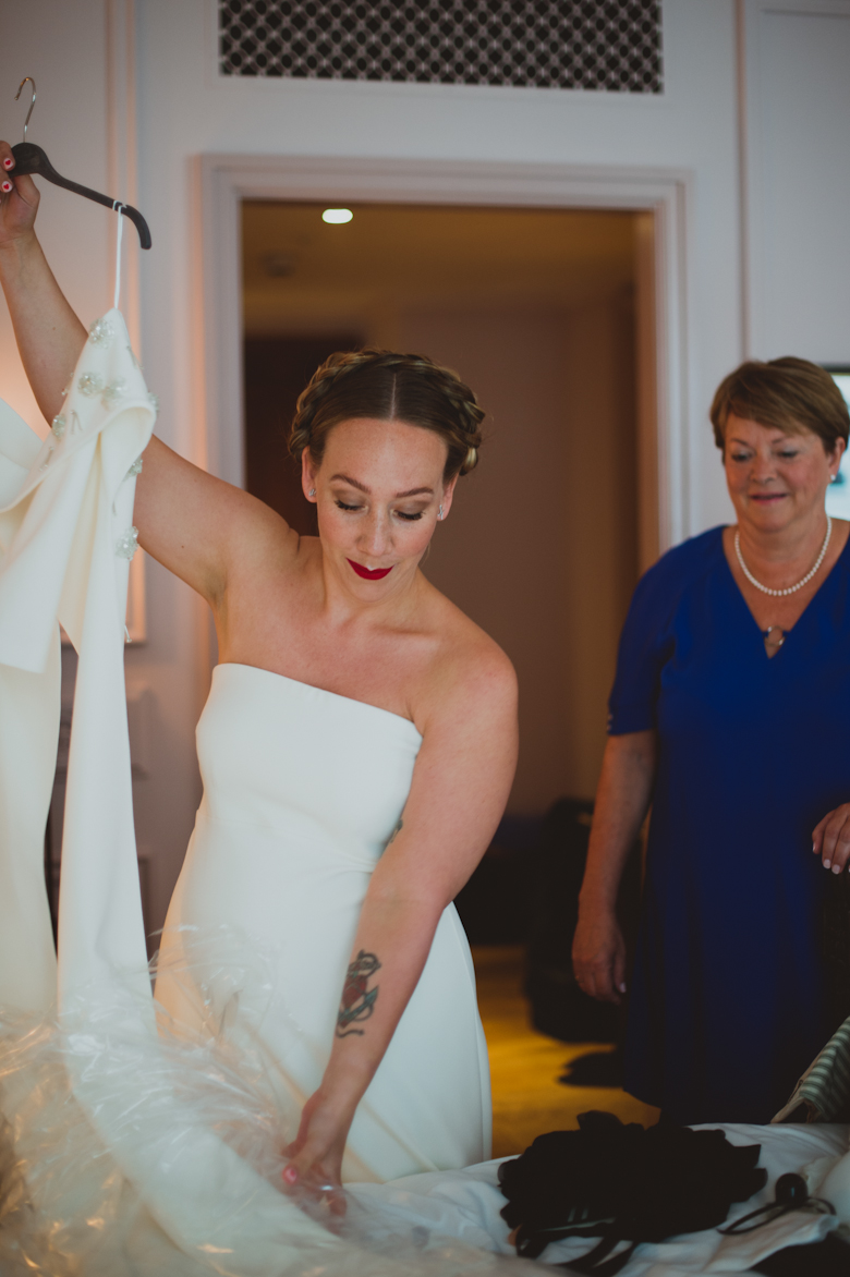 bride with baby bump getting ready in her 50's dress