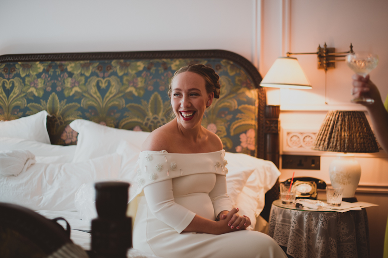 bride laughing and getting ready in her 50's dress