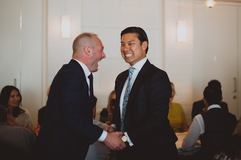 Groom and best man laughing