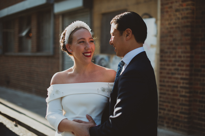 Bride and groom laughing outside the Bistrotheque, East London Wedding