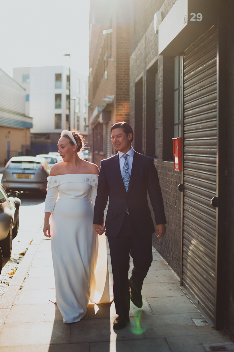 Bride and groom walk outside the Bistrotheque, East London Wedding