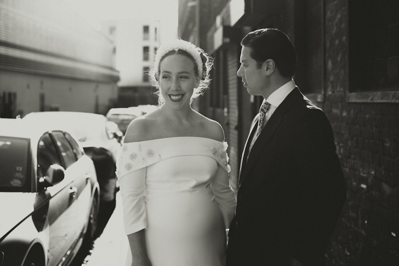 Bride and groom laughing outside the Bistrotheque, East London Wedding
