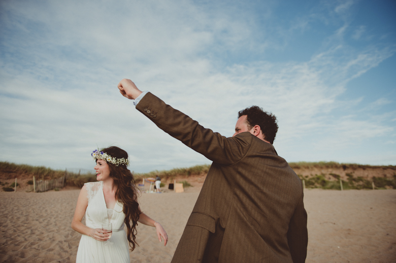 bride and groom on a beach having fun